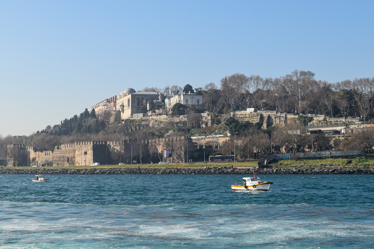 Istanbul shoreline seen from the water, with city walls and fishing boats